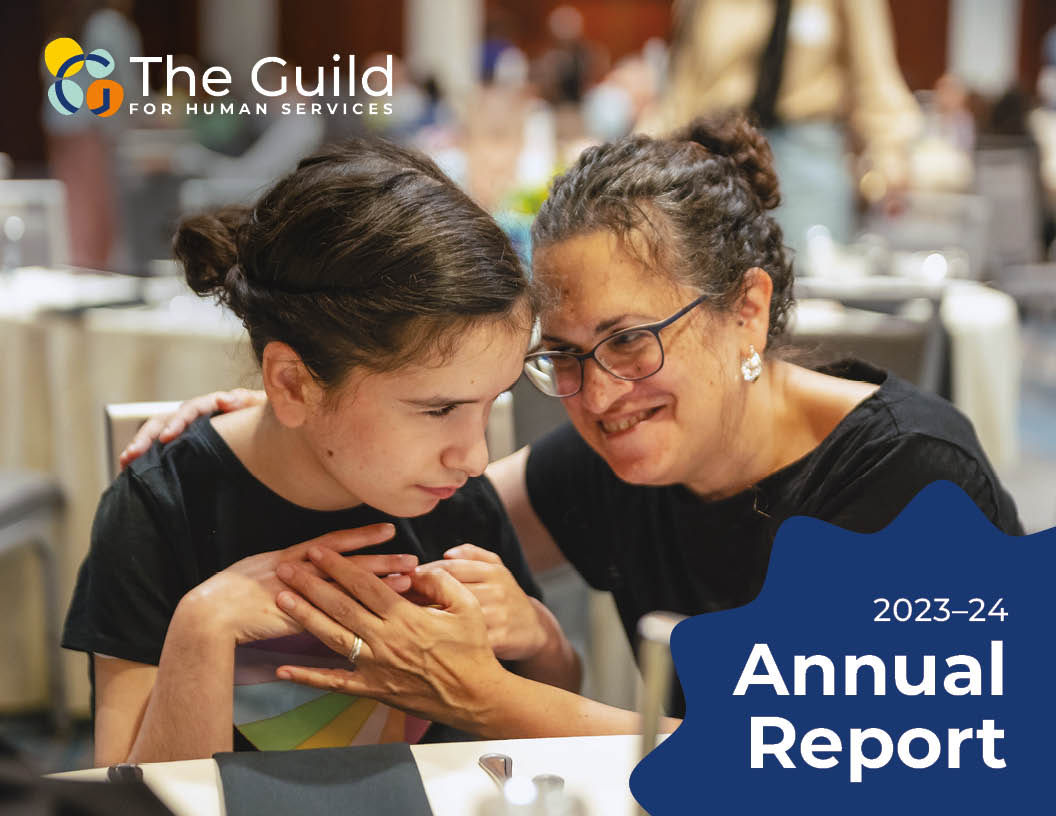 A mom and daughter wearing similar black tops sit at a table with their heads leaning close together. A blue starburst shape has the text "2023-24 Annual Report" in the bottom corner.